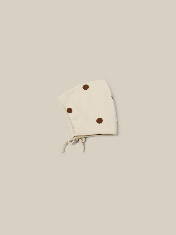 baby and toddler undyed cotton pixie bonnet in cream with brown dots and chin tie