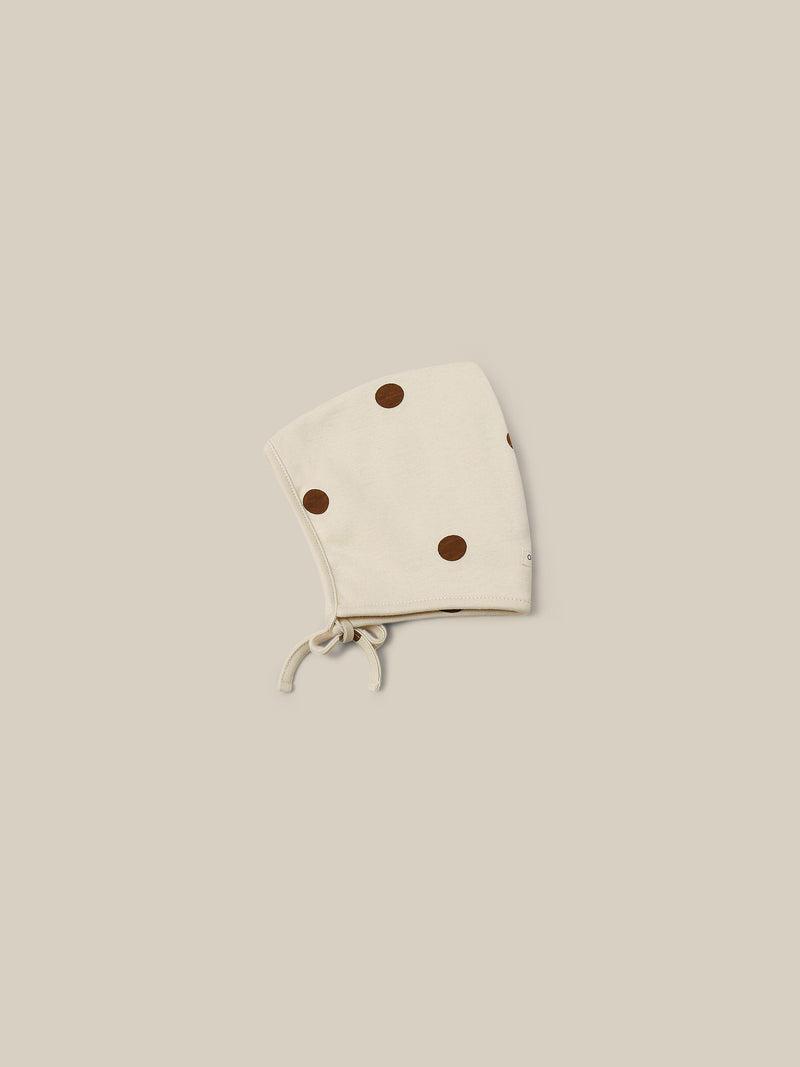 baby and toddler undyed cotton pixie bonnet in cream with brown dots and chin tie