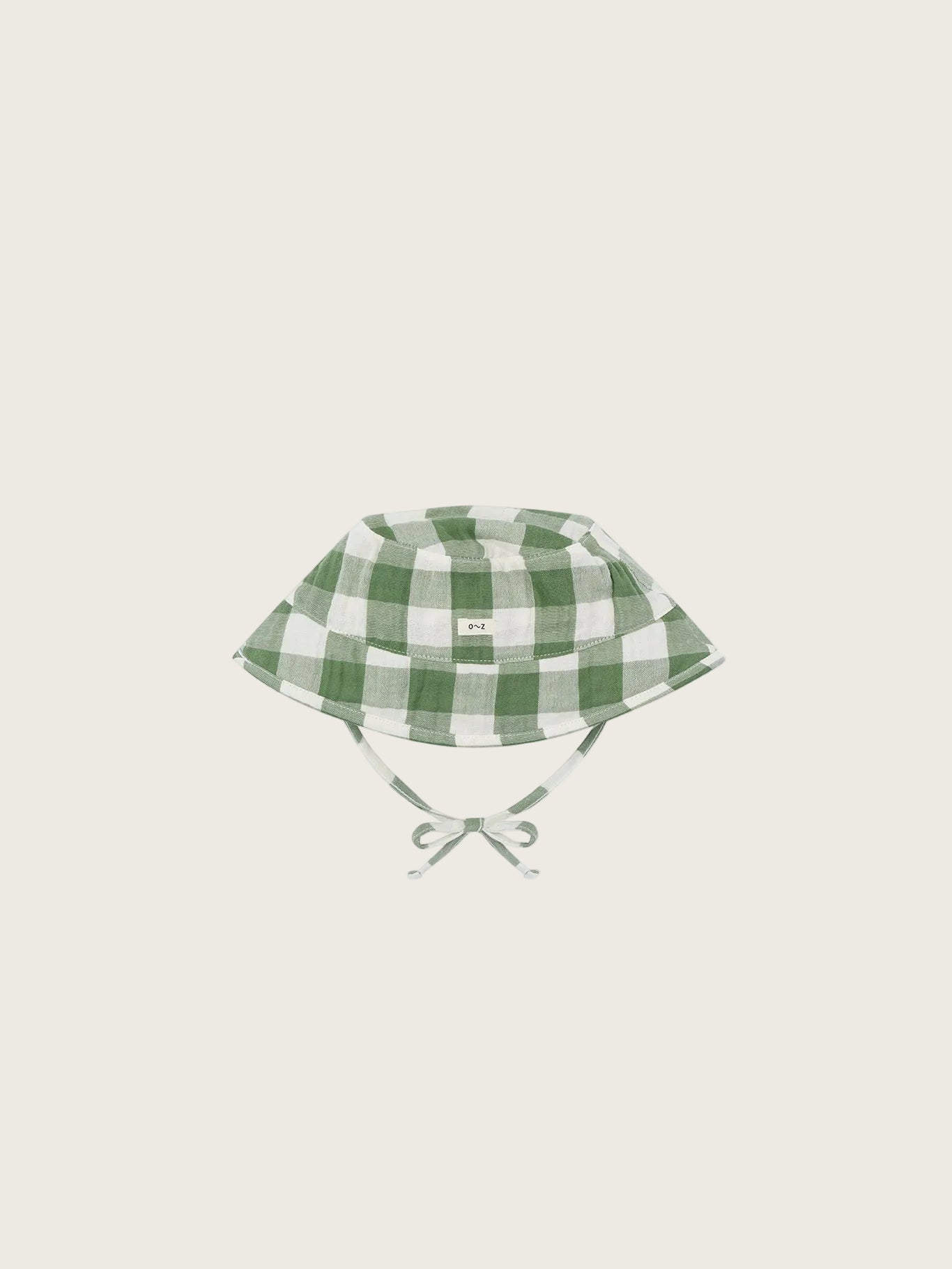 Green and white checkered baby hat on a white background