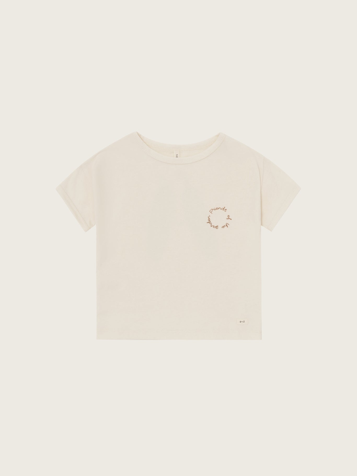 Beige t-shirt with a small graphic on a light beige background