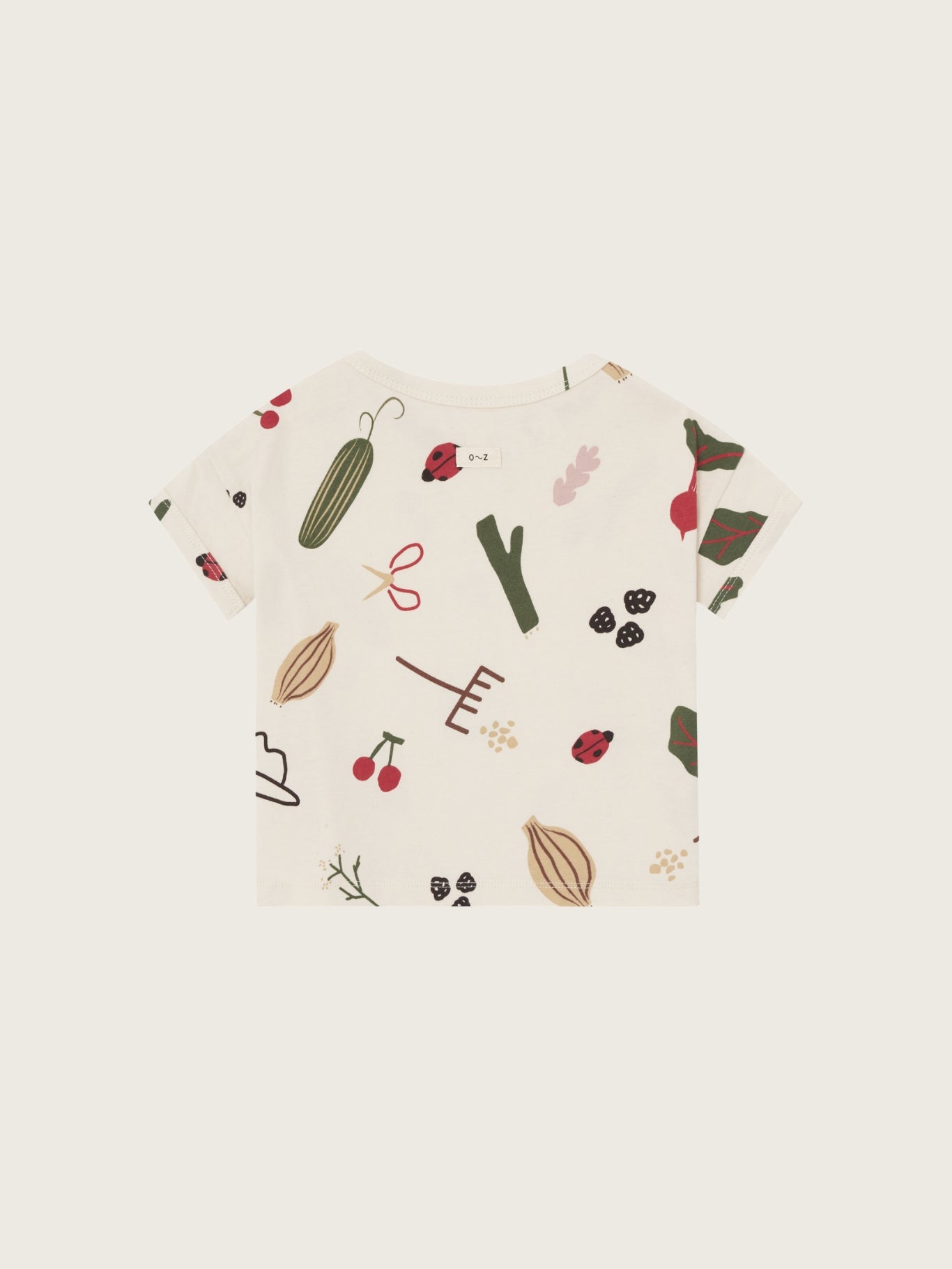 Baby t-shirt with vegetable pattern on a white background