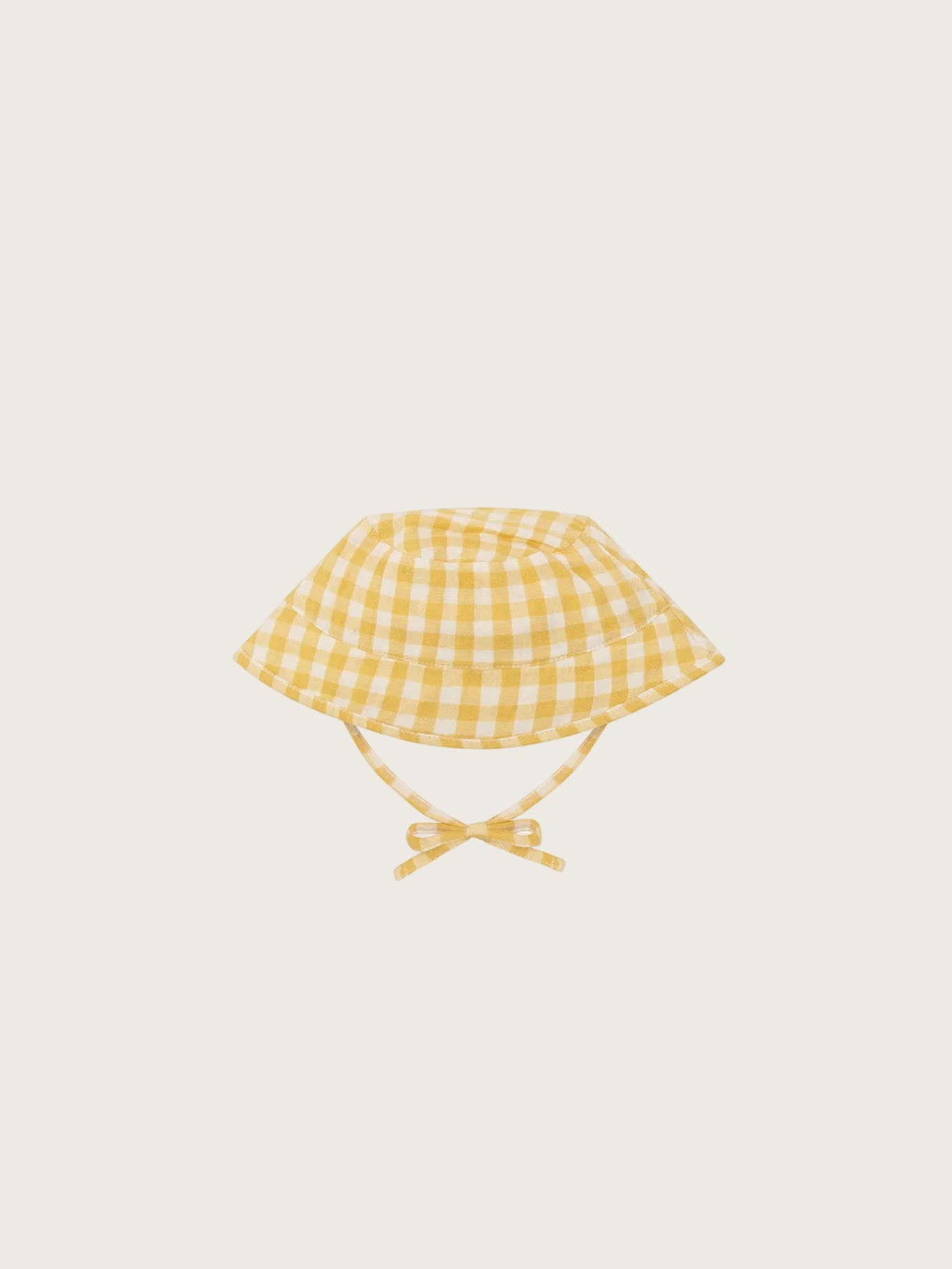 Yellow checkered baby hat with a bow on a white background