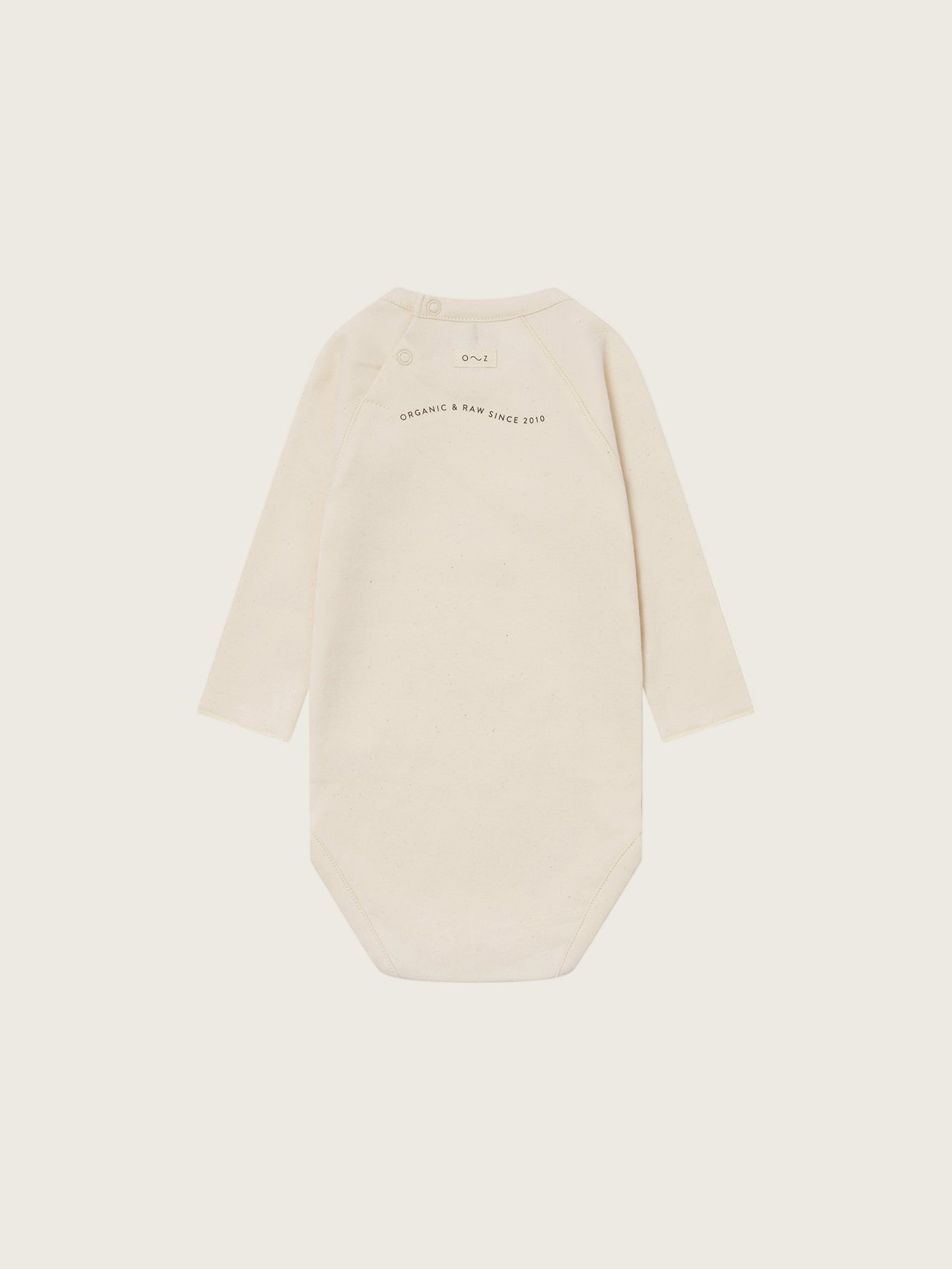 baby cream undyed cotton bodysuit with organic & raw since 2010 slogan