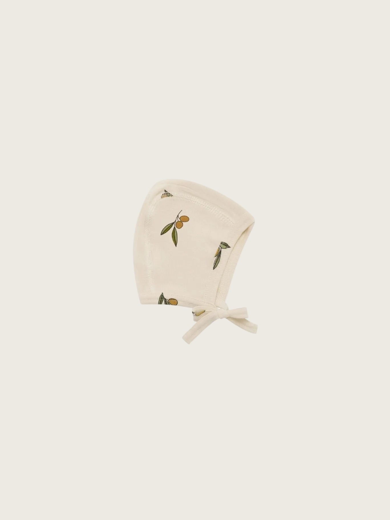 Beige baby bonnet with olive pattern on a white background