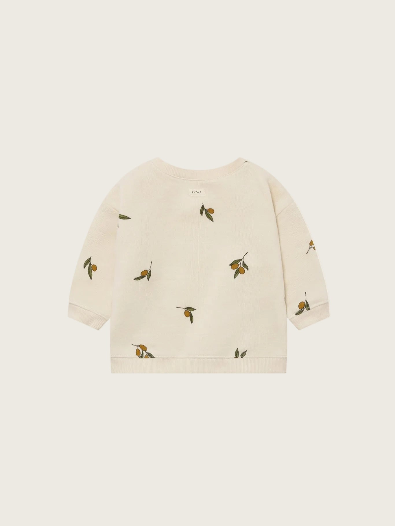 Beige sweater with olive patterns on a white background