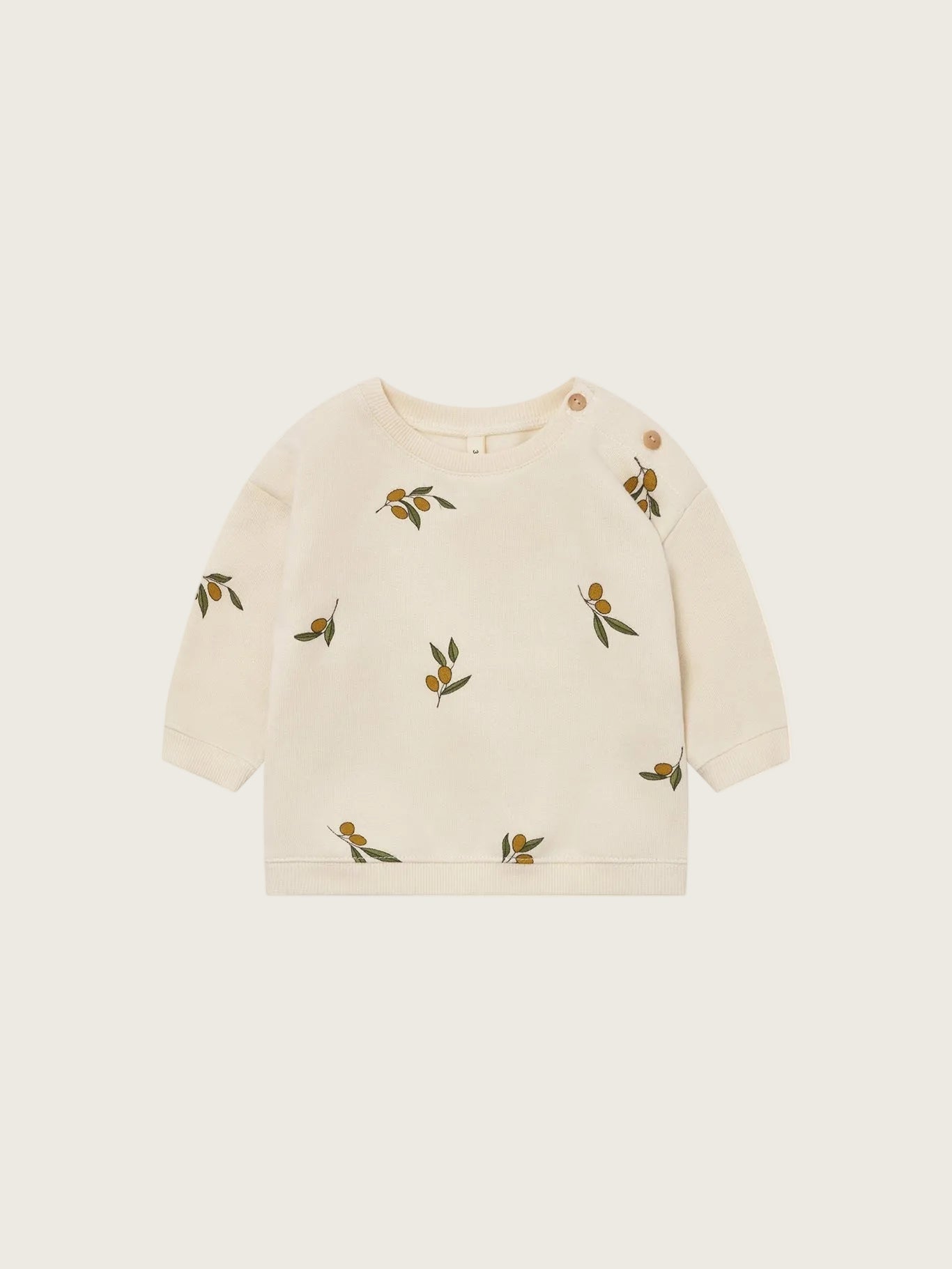 Beige sweater with olive patterns on a white background