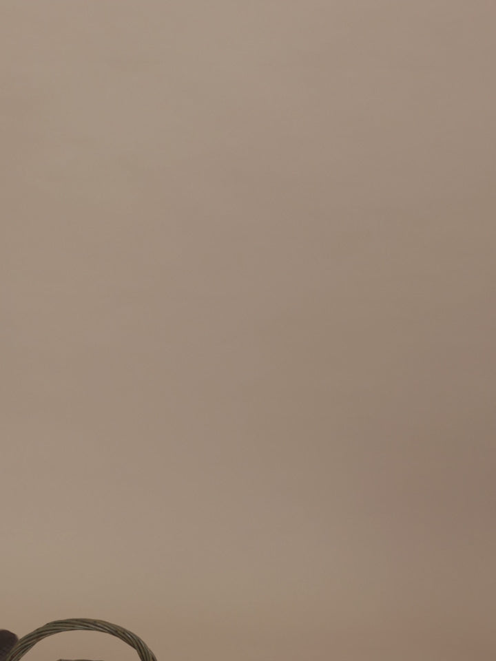 toddler in matching cream sweatshirt and pants with green clover print, climbing onto a chair