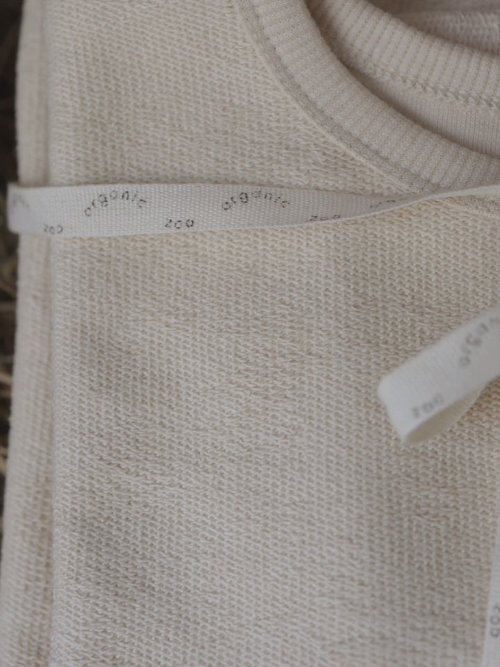 close up video of toddler & women's cream cotton sweatshirt with O ~ Z embroidered in green