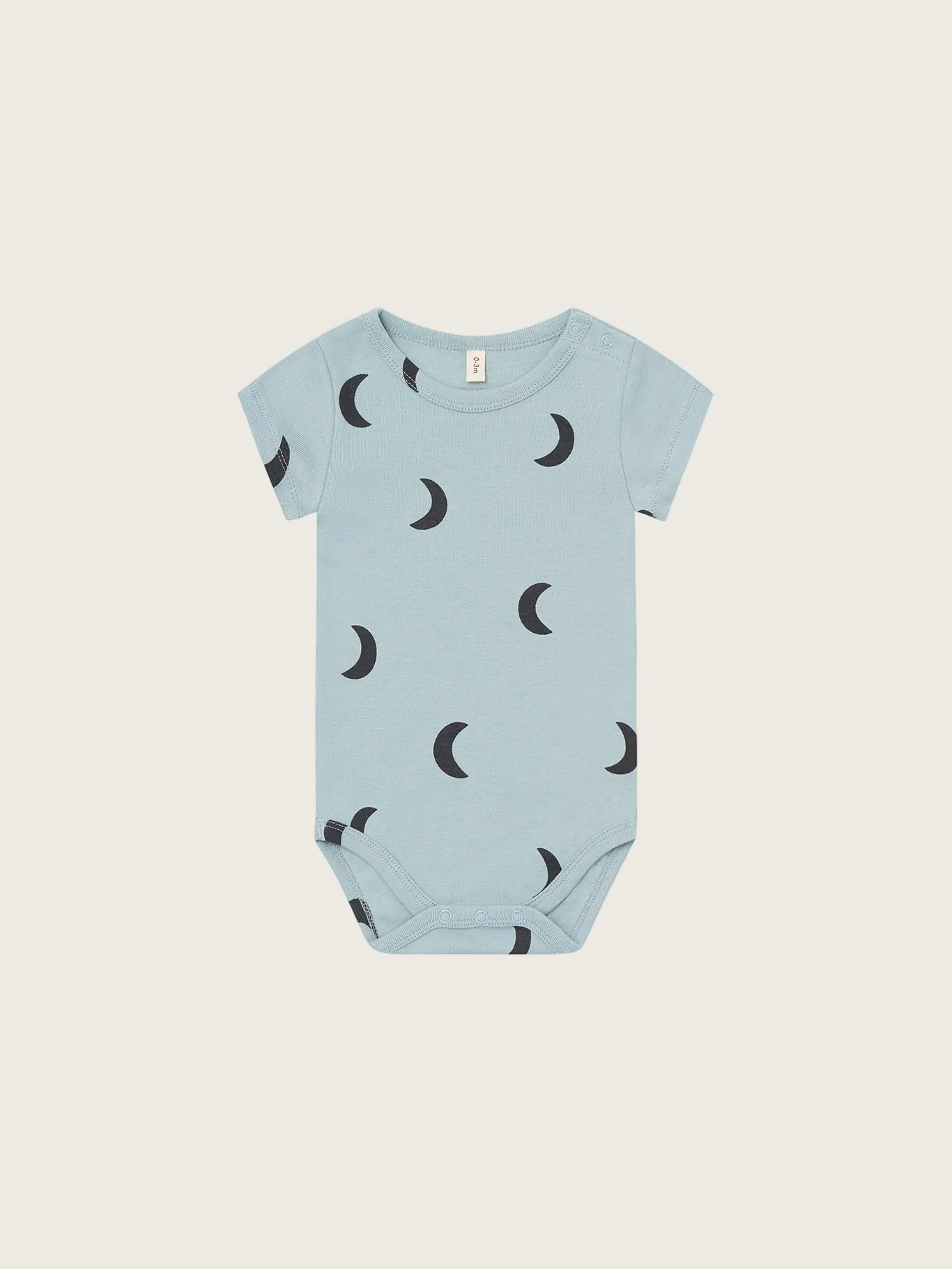 Light blue baby onesie with black moon pattern on a white background