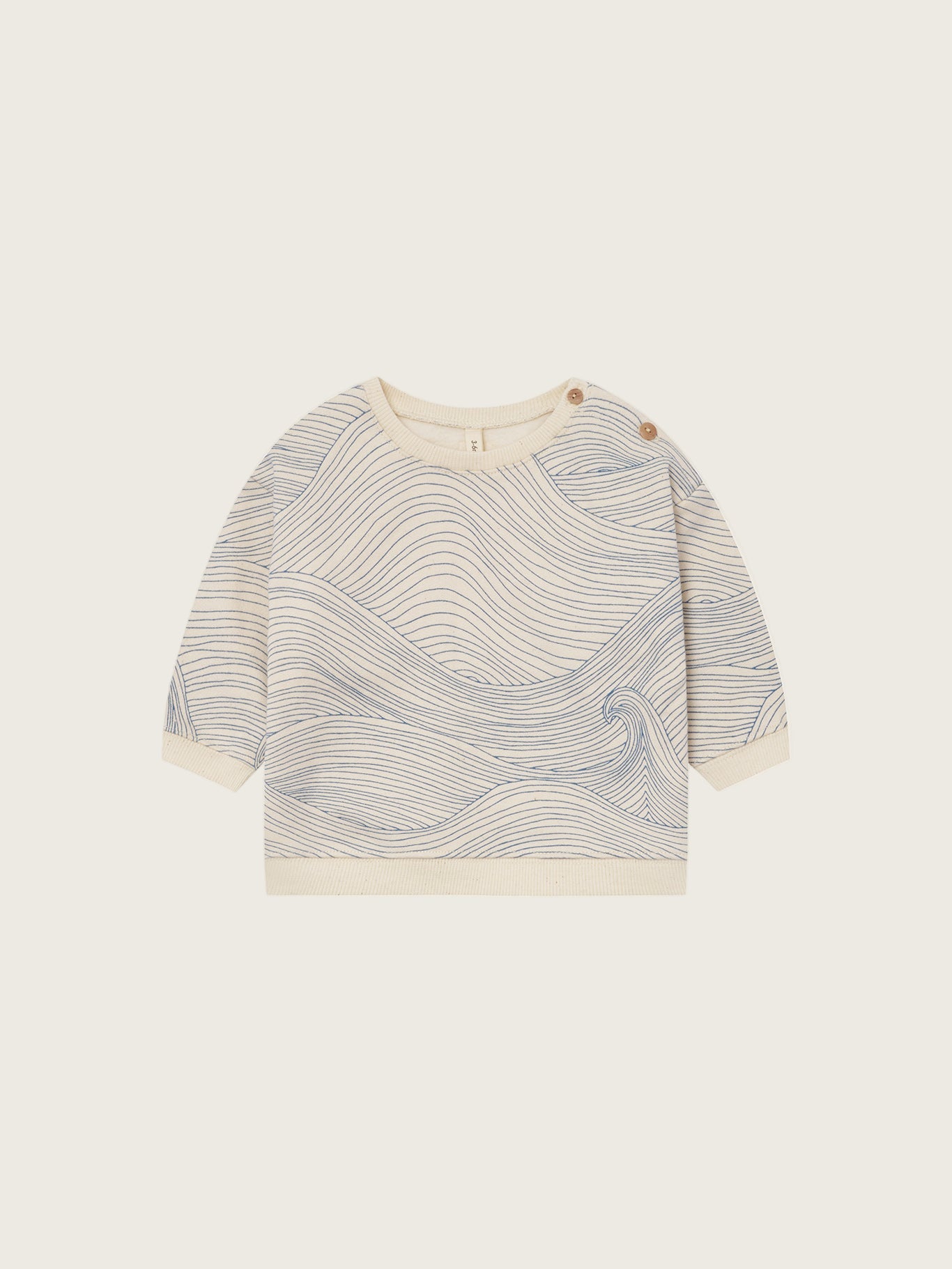 baby cream undyed cotton sweatshirt with shoulder buttons and blue Seascape line-drawn ocean waves