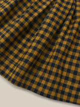 close up of checkered navy and yellow gingham pinafore flannel skirt with adjustable straps