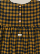 close up of checkered navy & yellow gingham flannel dress with gathered waist & three buttons at the back