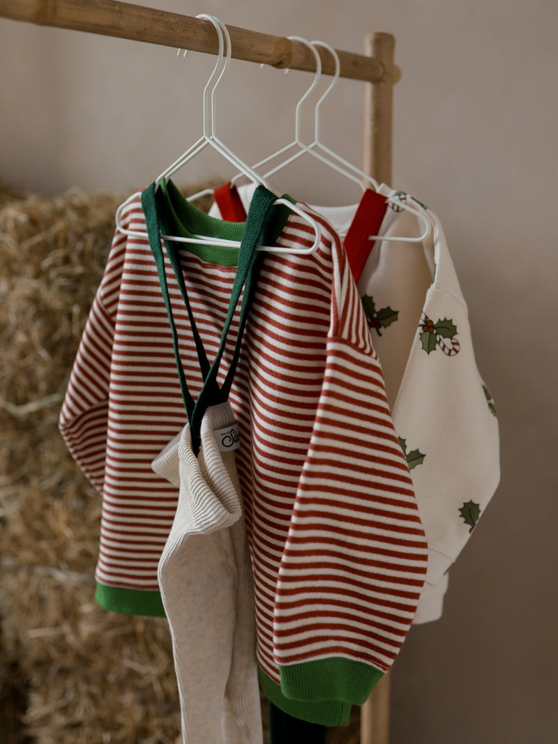 toddler christmas holly & candy cane sweatshirt red stripes sweatshirt & tights hanging on rack