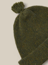 close up of wool beanie in forest green with tassel