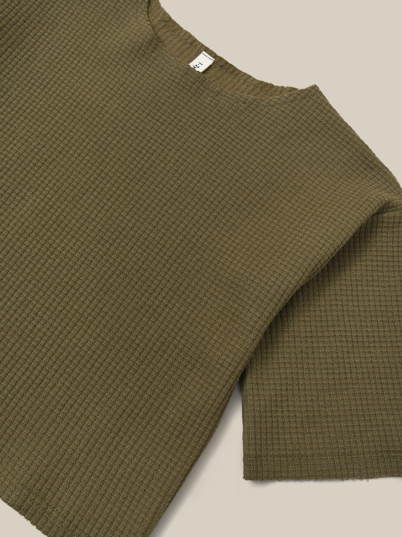 close up of boxy cotton waffle sweatshirt in green