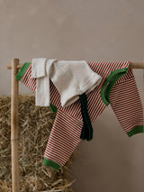 toddler christmas organic red stripes sweatshirt & tights with braces hanging on rack