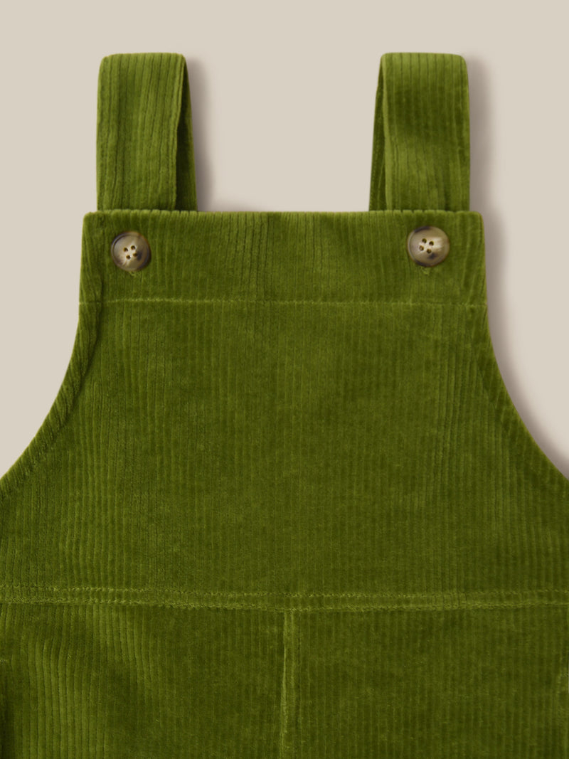 close up of cotton cord oversized farmers dungarees in green with & side in-seam pockets with gingham finish