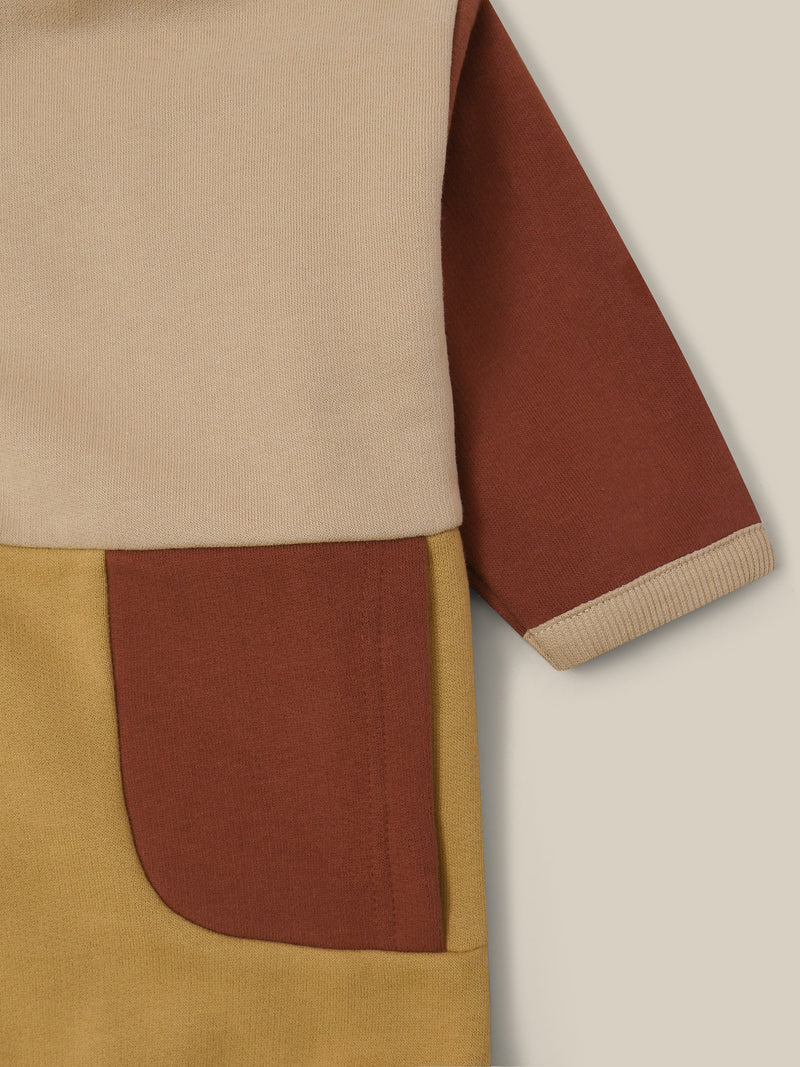 close up of terry cotton colour block beige sweater with brown and dark yellow details and front poppers