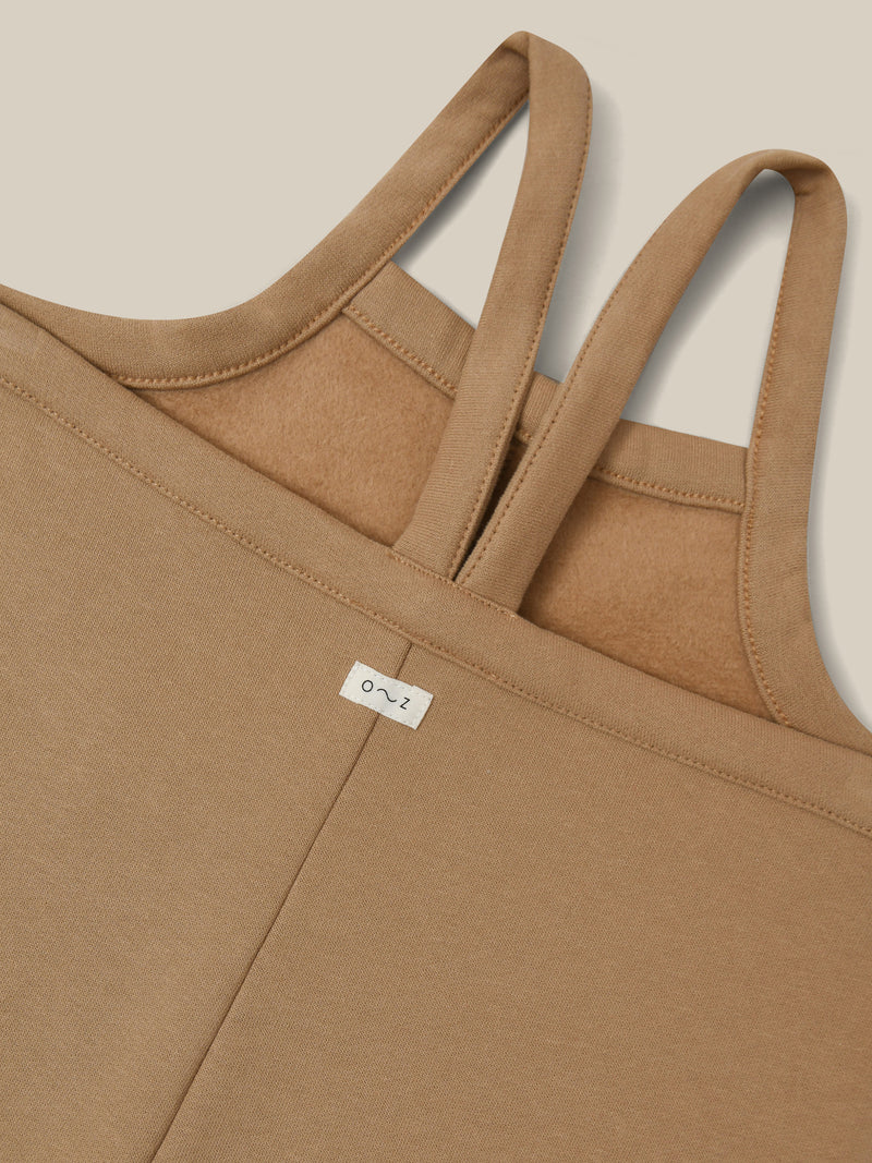 close up of oversized boxy terry cotton dungarees in beige