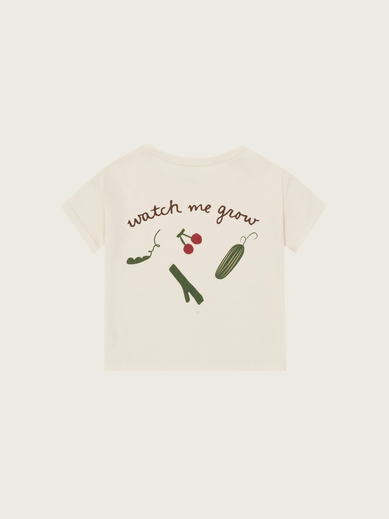 Beige t-shirt with 'watch me grow' text and illustrations on a white background