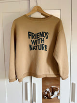 women's FRIENDS WITH NATURE slogan sweatshirt hanging on wardrobe with mirror